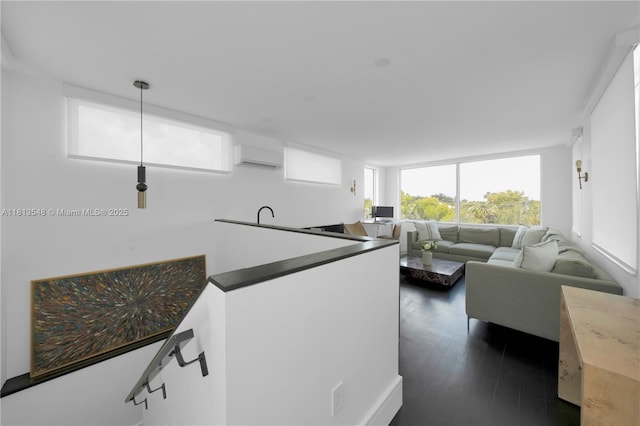 6320 Dolphin Dr, Coral Gables, FL 33158 - living area with a wall unit AC and dark wood-type flooring