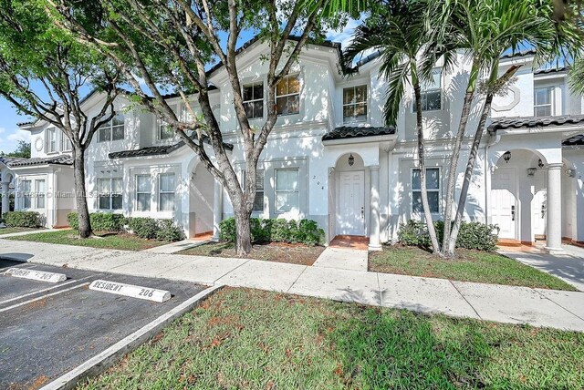 5440NW 107th Ave Unit 204, Doral, FL 33178 - townhome / multi-family property with stucco siding, uncovered parking, and a tiled roof