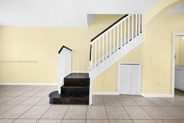 5440NW 107th Ave Unit 204, Doral, FL 33178 - stairway with tile patterned flooring, arched walkways, and baseboards