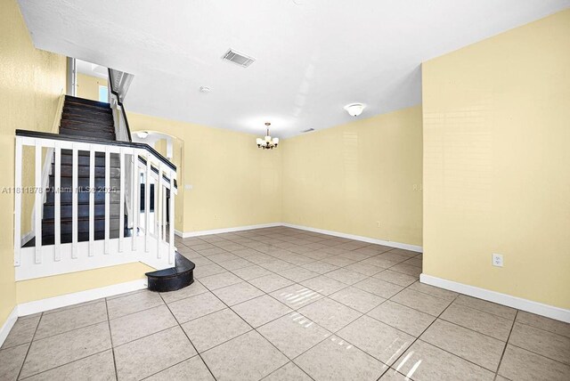 5440NW 107th Ave Unit 204, Doral, FL 33178 - empty room featuring stairs, a chandelier, tile patterned floors, and baseboards