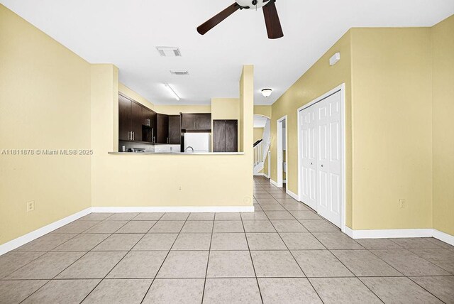 5440NW 107th Ave Unit 204, Doral, FL 33178 - unfurnished living room featuring ceiling fan, light tile patterned flooring, and baseboards