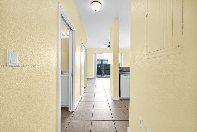 5440NW 107th Ave Unit 204, Doral, FL 33178 - corridor with a textured wall, light tile patterned floors, and baseboards