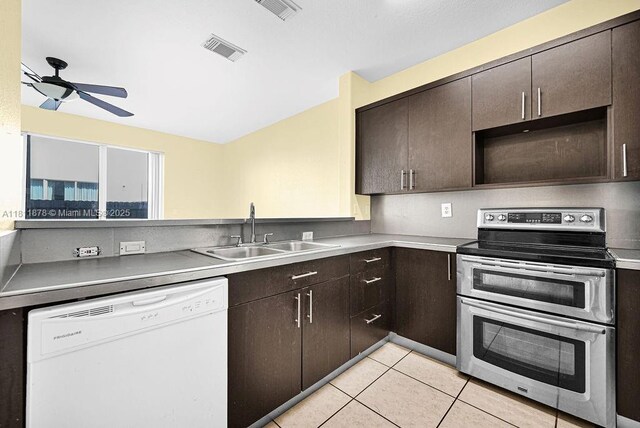 5440NW 107th Ave Unit 204, Doral, FL 33178 - kitchen featuring white dishwasher, range with two ovens, a sink, ceiling fan, and dark brown cabinets