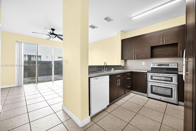 5440NW 107th Ave Unit 204, Doral, FL 33178 - kitchen with dishwasher, range with two ovens, a sink, a ceiling fan, and light tile patterned floors