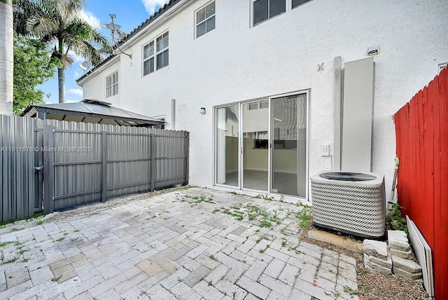 5440NW 107th Ave Unit 204, Doral, FL 33178 - fenced backyard featuring cooling unit, a patio area, and a gazebo