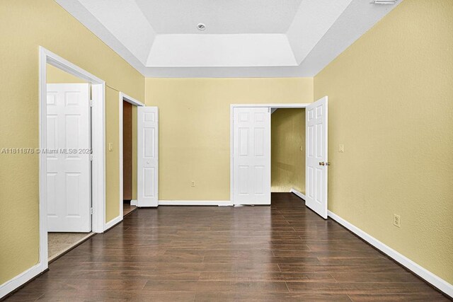 5440NW 107th Ave Unit 204, Doral, FL 33178 - unfurnished bedroom featuring wood finished floors, a raised ceiling, and baseboards