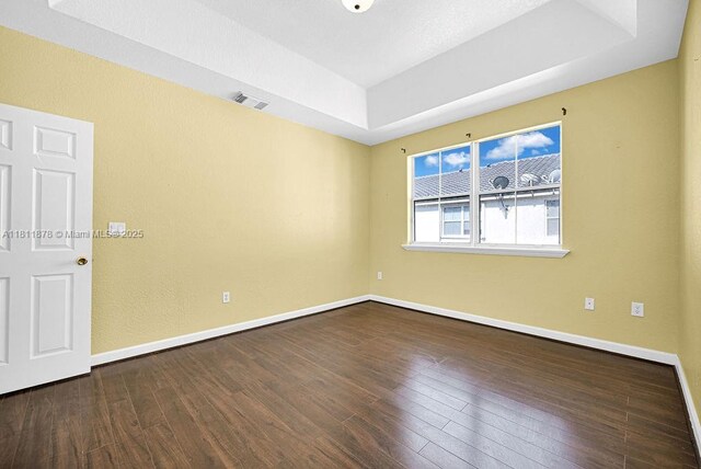 5440NW 107th Ave Unit 204, Doral, FL 33178 - spare room with a tray ceiling, wood finished floors, and baseboards