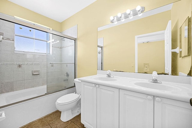 5440NW 107th Ave Unit 204, Doral, FL 33178 - bathroom featuring toilet, double vanity, tile patterned floors, and enclosed tub / shower combo
