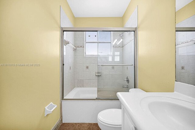 5440NW 107th Ave Unit 204, Doral, FL 33178 - full bathroom featuring toilet, vanity, enclosed tub / shower combo, baseboards, and tile patterned flooring