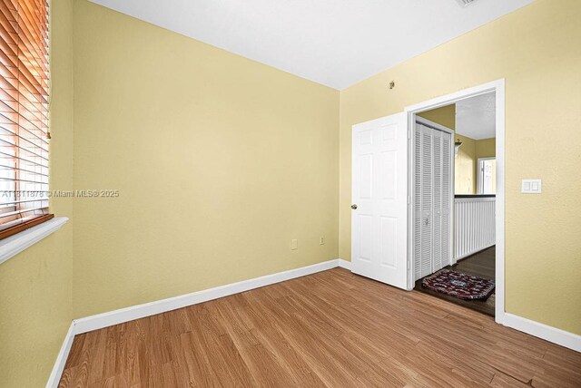 5440NW 107th Ave Unit 204, Doral, FL 33178 - empty room featuring wood finished floors and baseboards