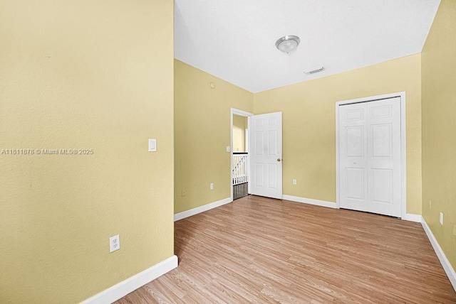 5440NW 107th Ave Unit 204, Doral, FL 33178 - unfurnished bedroom featuring light wood-type flooring and baseboards