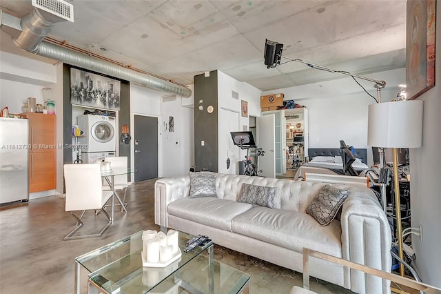 10 SW S River Dr Unit Ph108, Miami, FL 33130 - living area featuring stacked washer / dryer and concrete floors