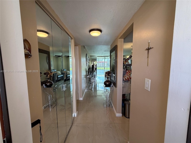 2851 E Sunrise Lakes Dr Unit 205, Sunrise, FL 33322 - corridor with a textured ceiling, light tile patterned floors, and baseboards