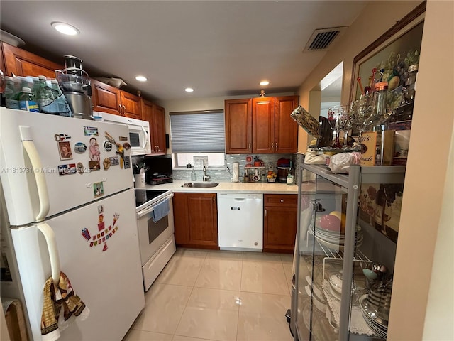 2851 E Sunrise Lakes Dr Unit 205, Sunrise, FL 33322 - kitchen with white appliances, a sink, light countertops, light tile patterned flooring, and brown cabinets