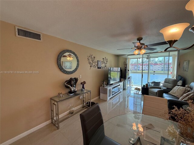 2851 E Sunrise Lakes Dr Unit 205, Sunrise, FL 33322 - dining area with a textured ceiling, baseboards, and a ceiling fan