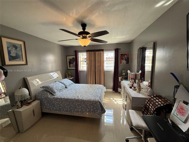 2851 E Sunrise Lakes Dr Unit 205, Sunrise, FL 33322 - bedroom featuring multiple windows, a textured ceiling, ceiling fan, and light tile patterned floors