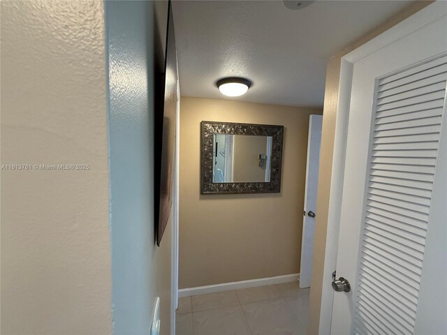 2851 E Sunrise Lakes Dr Unit 205, Sunrise, FL 33322 - corridor featuring baseboards and a textured ceiling