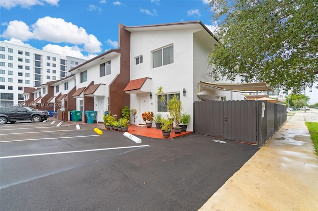 401 SW 109th Ave Unit 26, Sweetwater, FL 33174 - exterior space with stucco siding, uncovered parking, and a gate