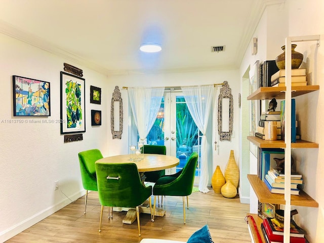928 NE 18th Ct, Fort Lauderdale, FL 33305 - dining space with crown molding, wood finished floors, baseboards, and french doors