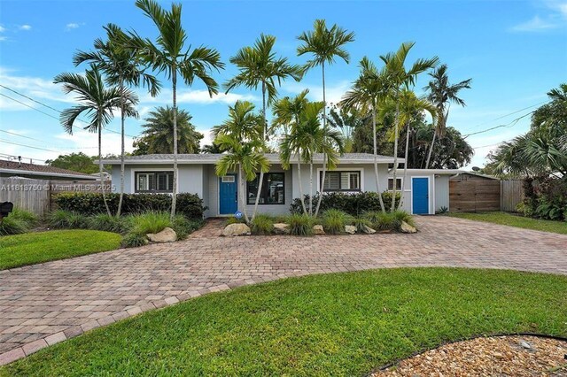 928 NE 18th Ct, Fort Lauderdale, FL 33305 - view of front of home with stucco siding and driveway