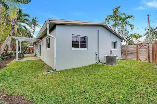 928 NE 18th Ct, Fort Lauderdale, FL 33305 - view of property exterior featuring cooling unit and stucco siding