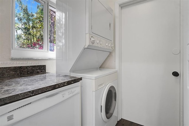 928 NE 18th Ct, Fort Lauderdale, FL 33305 - laundry room with stacked washer and clothes dryer and dark wood-type flooring