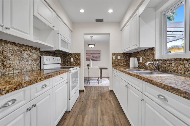 928 NE 18th Ct, Fort Lauderdale, FL 33305 - kitchen featuring white appliances, a sink, white cabinetry, dark wood-style flooring, and recessed lighting