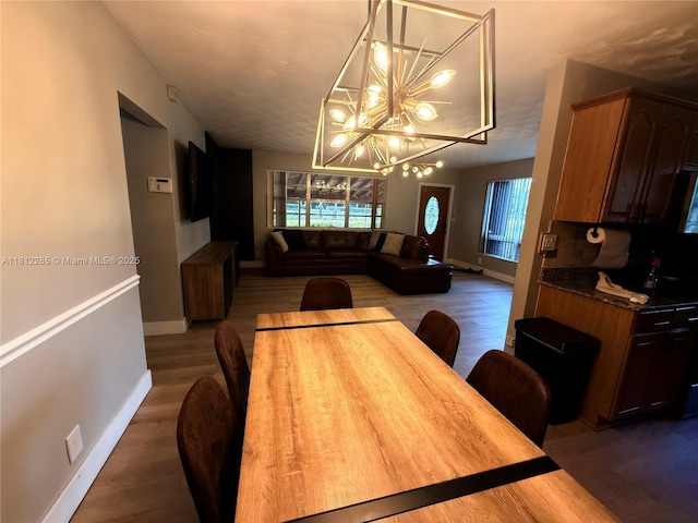2430 N 61st Ter, Hollywood, FL 33024 - dining space with a chandelier, wood finished floors, and baseboards
