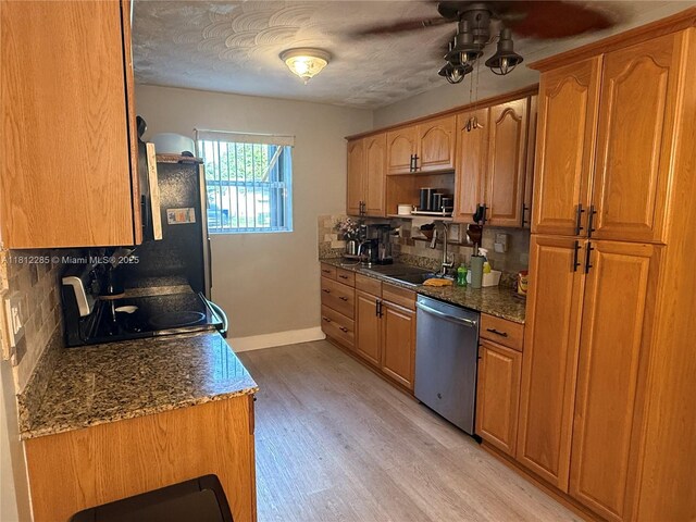 2430 N 61st Ter, Hollywood, FL 33024 - kitchen with stainless steel appliances, a sink, decorative backsplash, light wood finished floors, and baseboards