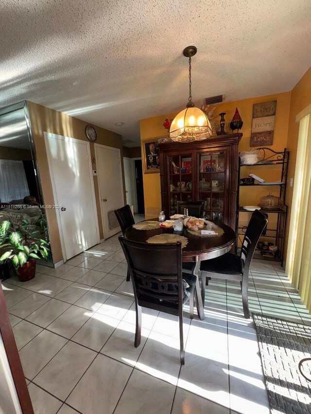 20420 NW 24th Ct, Miami Gardens, FL 33056 - dining room with light tile patterned floors and a textured ceiling