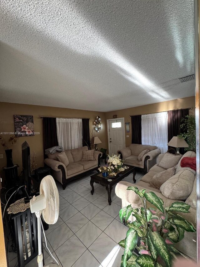 20420 NW 24th Ct, Miami Gardens, FL 33056 - living room featuring light tile patterned floors and a textured ceiling