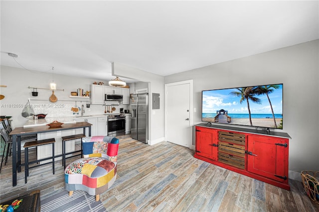 1614 W Ave Unit 306, Miami Beach, FL 33139 - living area with light wood finished floors and electric panel