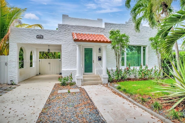 276 NE 90th St, El Portal, FL 33138 - mediterranean / spanish home featuring stucco siding, a tiled roof, and a gate