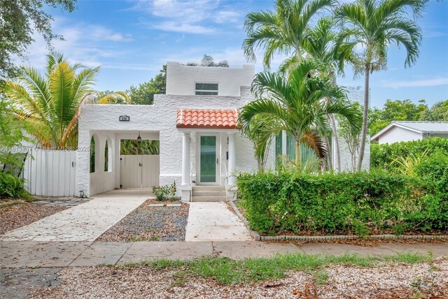 276 NE 90th St, El Portal, FL 33138 - mediterranean / spanish-style home with stucco siding, a gate, a tile roof, and driveway
