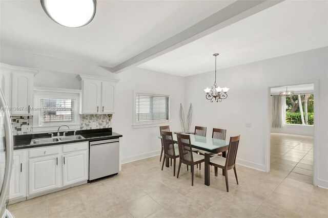 276 NE 90th St, El Portal, FL 33138 - kitchen with dishwashing machine, a sink, dark countertops, and plenty of natural light