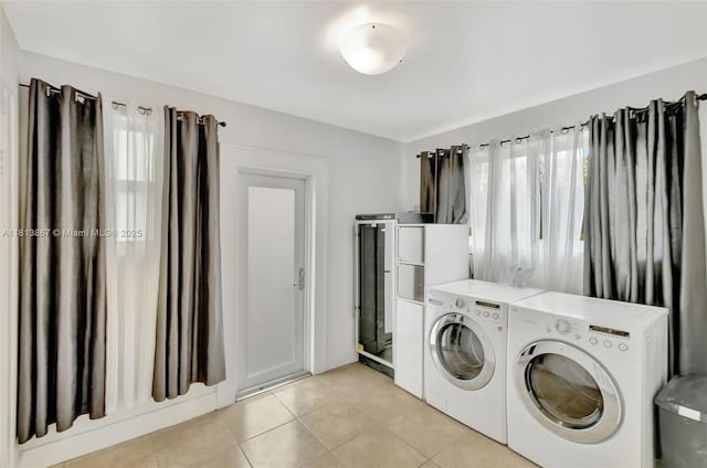 276 NE 90th St, El Portal, FL 33138 - laundry area with light tile patterned flooring and washing machine and dryer