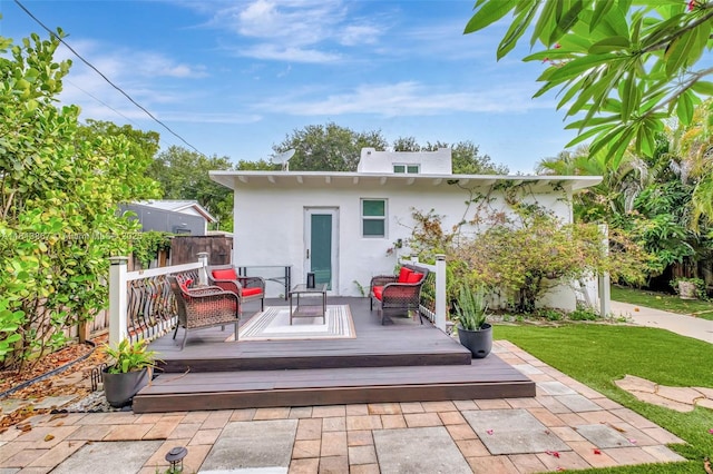 276 NE 90th St, El Portal, FL 33138 - rear view of house with an outdoor hangout area, stucco siding, and a wooden deck