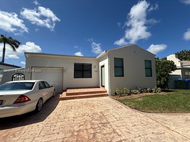 1525 SW 18th St, Miami, FL 33145 - single story home featuring decorative driveway, a garage, and stucco siding