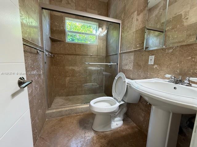 1525 SW 18th St, Miami, FL 33145 - bathroom with a shower stall and tile walls
