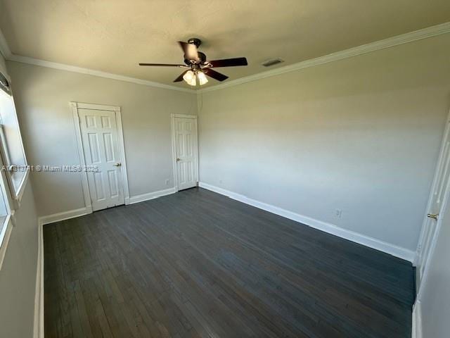 1525 SW 18th St, Miami, FL 33145 - unfurnished bedroom featuring dark wood-style floors, ornamental molding, two closets, and ceiling fan