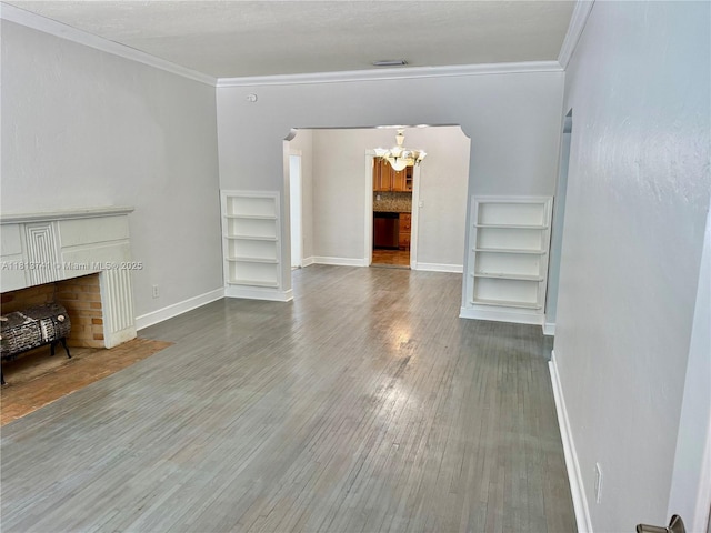 1525 SW 18th St, Miami, FL 33145 - unfurnished living room featuring a chandelier, built in features, wood finished floors, crown molding, and a fireplace with flush hearth