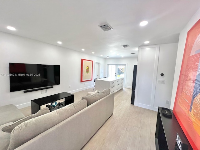 1451 NE 155th Ter, North Miami Beach, FL 33162 - living room with recessed lighting, light wood finished floors, and baseboards