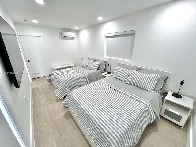 1451 NE 155th Ter, North Miami Beach, FL 33162 - bedroom featuring a wall mounted AC, recessed lighting, and light wood-style flooring