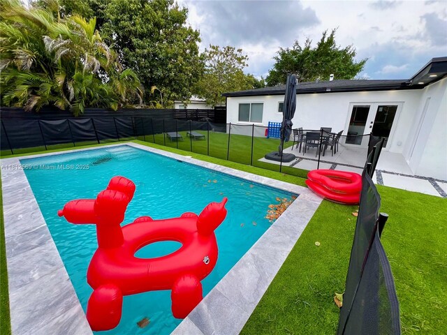 1451 NE 155th Ter, North Miami Beach, FL 33162 - view of swimming pool with a patio area