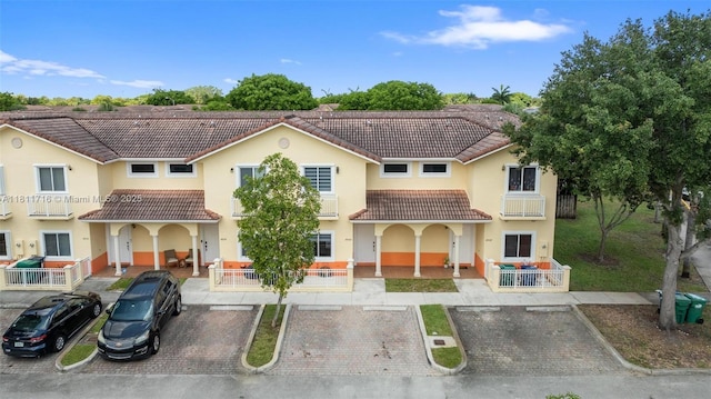 18062 NW 74th Ct, Hialeah, FL 33015 - view of front of home with a tile roof, a porch, and stucco siding