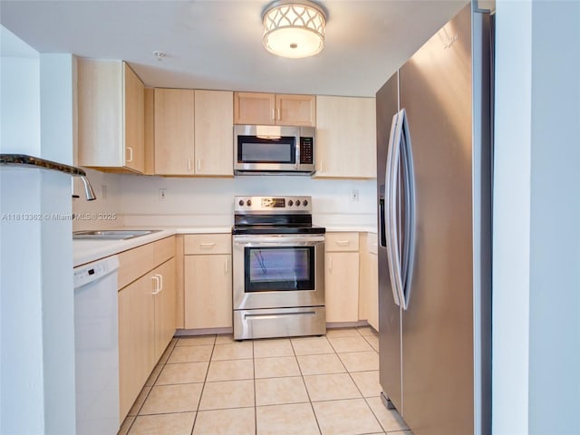 3000 Coral Way Unit 715, Miami, FL 33145 - kitchen with appliances with stainless steel finishes, light brown cabinets, light tile patterned floors, and light countertops