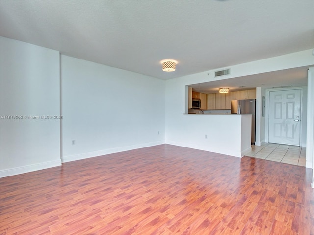 3000 Coral Way Unit 715, Miami, FL 33145 - unfurnished living room with light wood-style flooring and baseboards