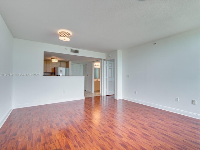 3000 Coral Way Unit 715, Miami, FL 33145 - unfurnished living room featuring wood finished floors and a textured ceiling