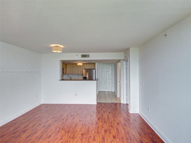 3000 Coral Way Unit 715, Miami, FL 33145 - unfurnished living room with wood finished floors and a textured ceiling