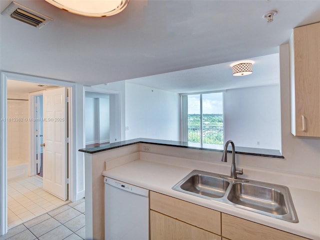 3000 Coral Way Unit 715, Miami, FL 33145 - kitchen with white dishwasher, light brown cabinetry, and light tile patterned floors